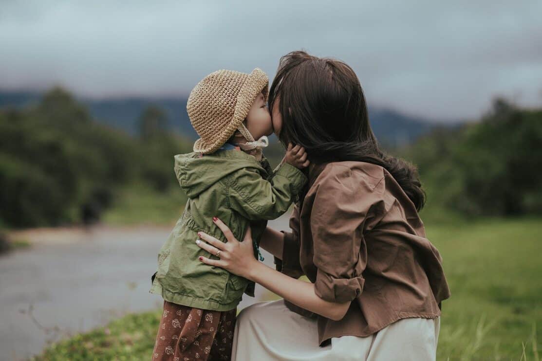 mother daughter kiss parent child 6935336